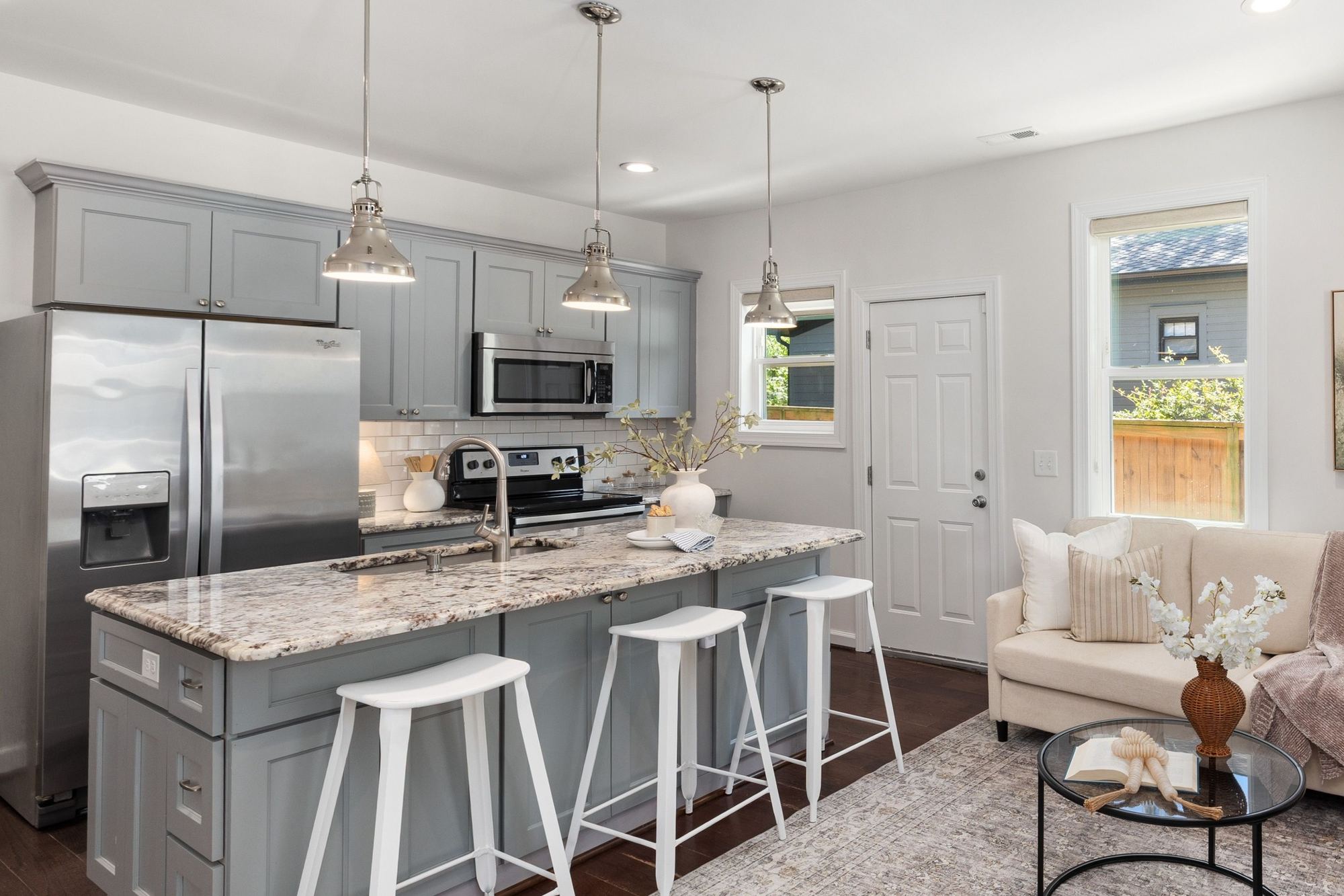 Stock image Gray kitchen with granite island, pendant lights, and stainless appliances in Northern California - optimized