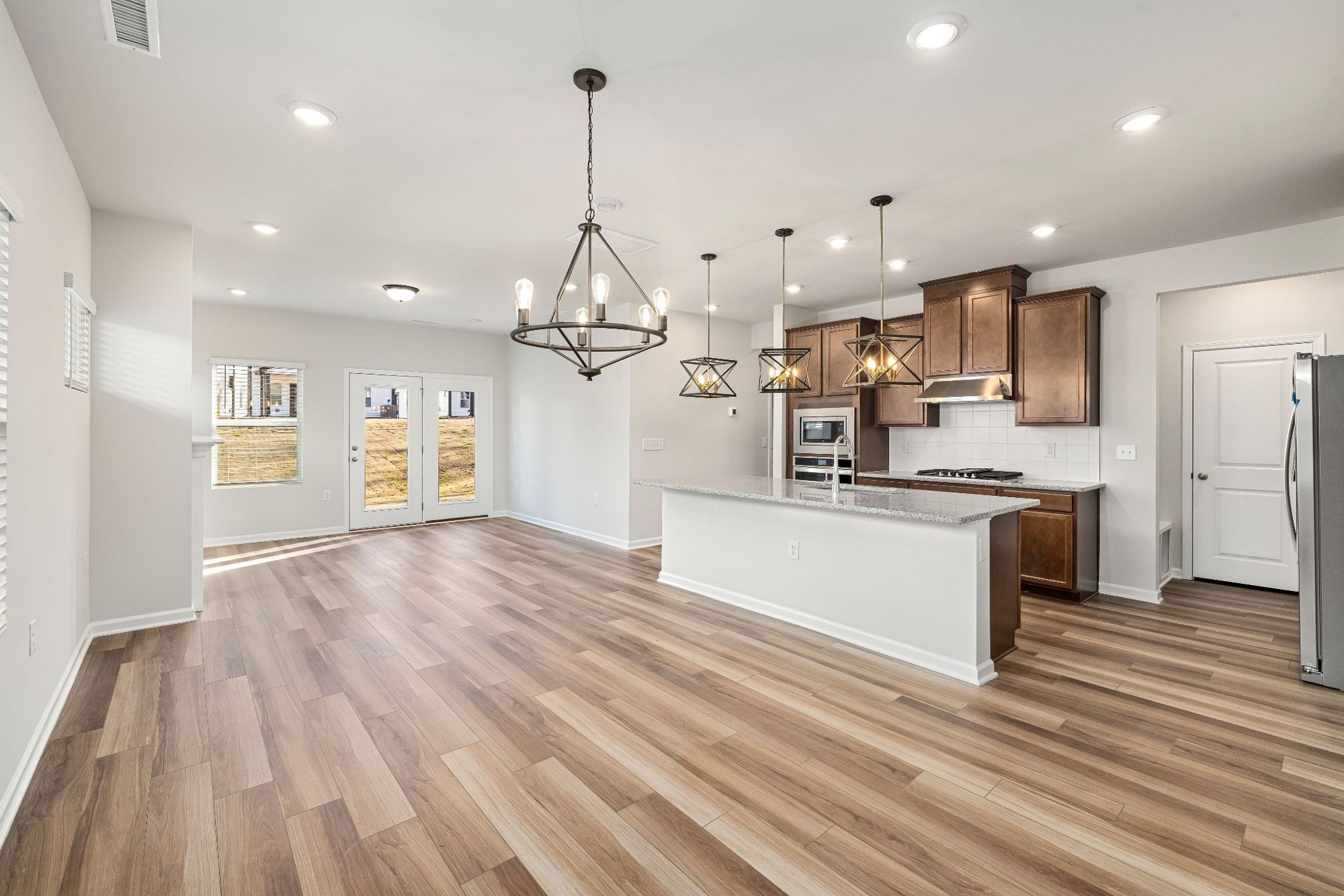 Stock image Open kitchen and dining area with wood cabinets and pendant lighting in Northern California - optimized