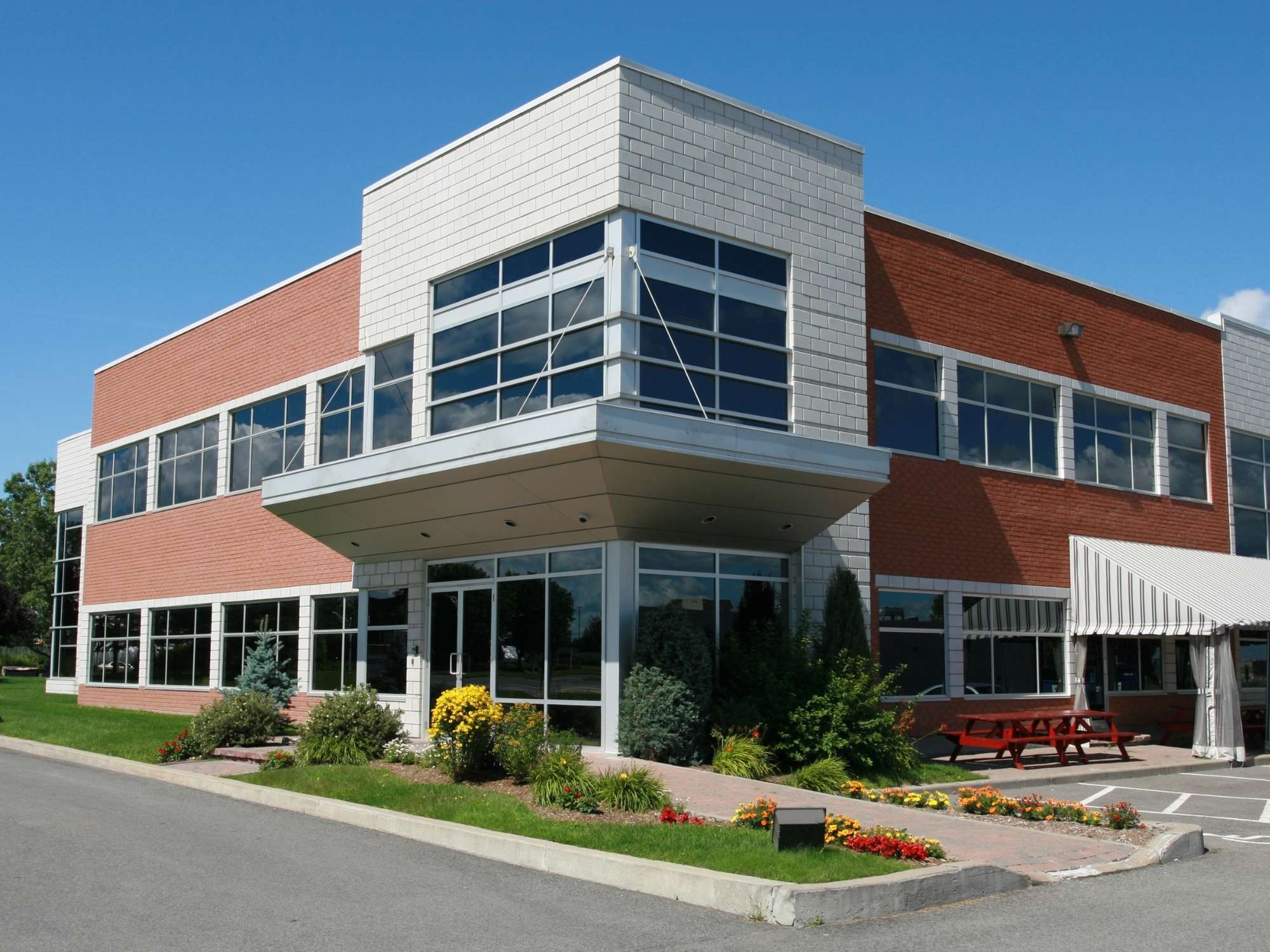 Stock image of a two-story commercial building with brick exterior, large windows, and modern entry in Northern California - optimized